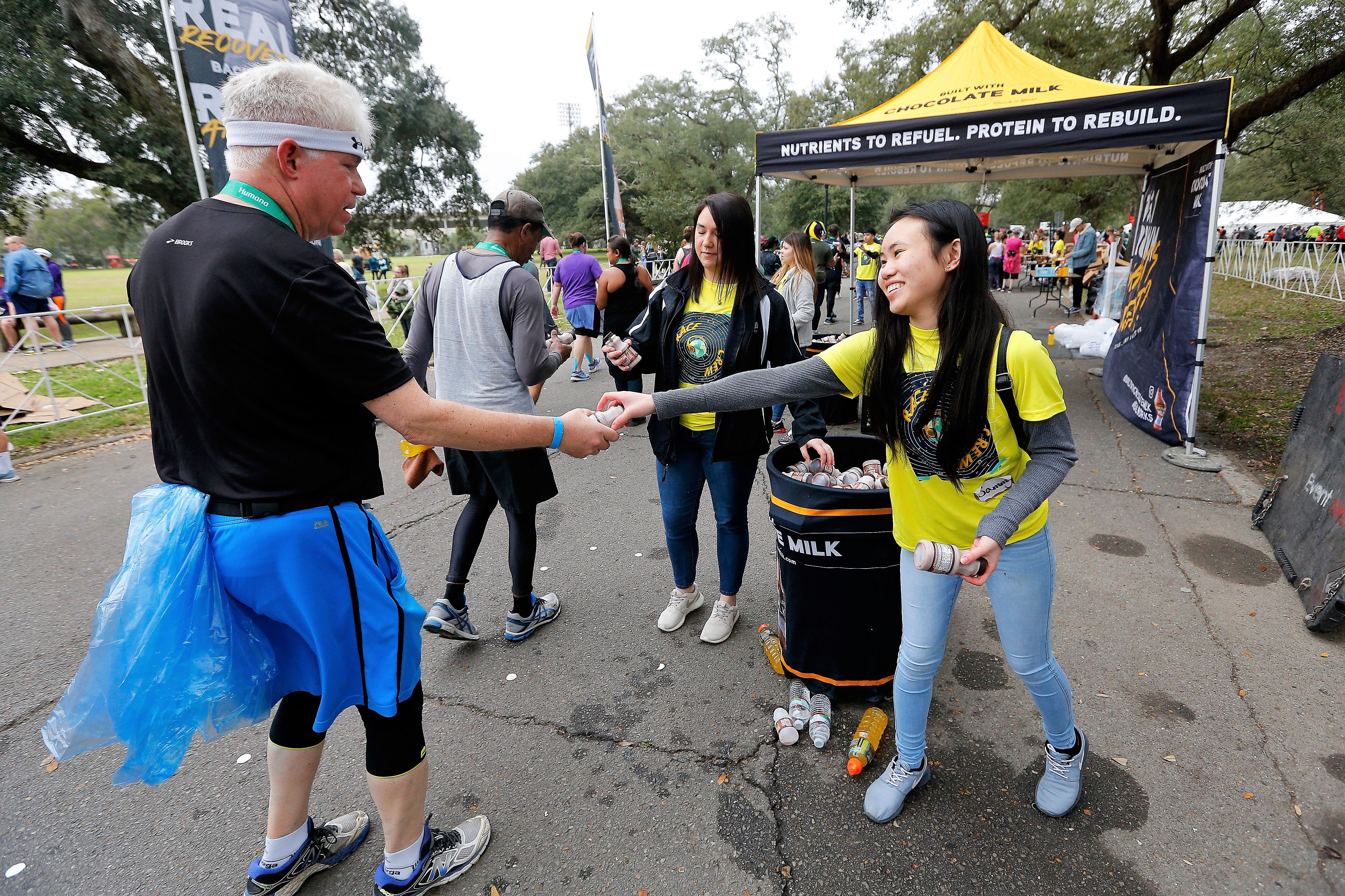 Volunteers Passing out Chocolate Milk to Runners