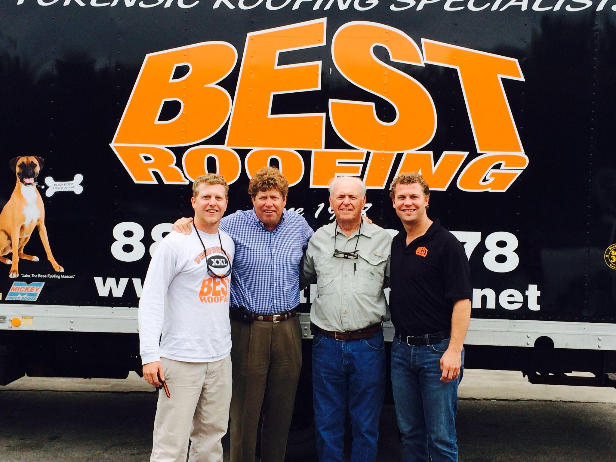 More members of the Best Roofing team in front of the Best Roofing logo