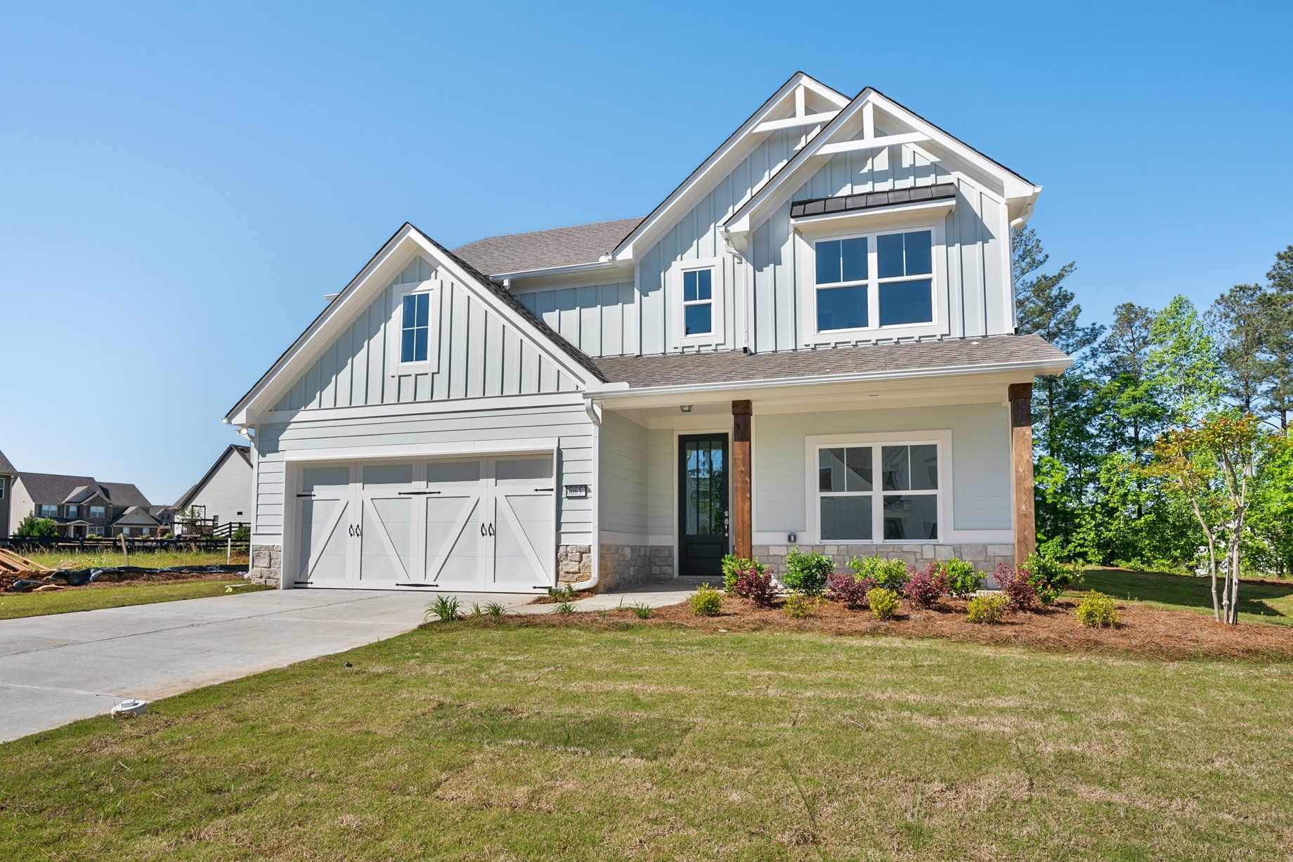 a house with a light blue exterior and a front yard