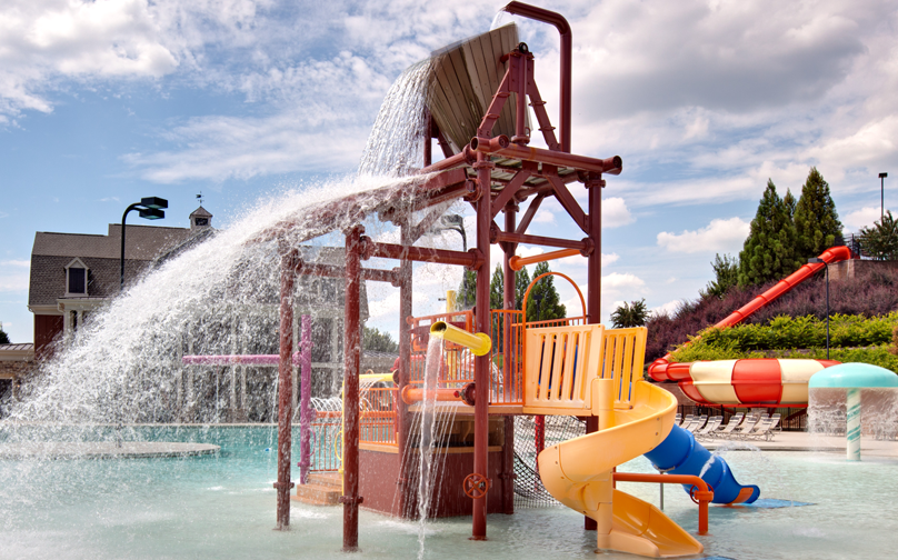 a water playground in the middle of the community pool