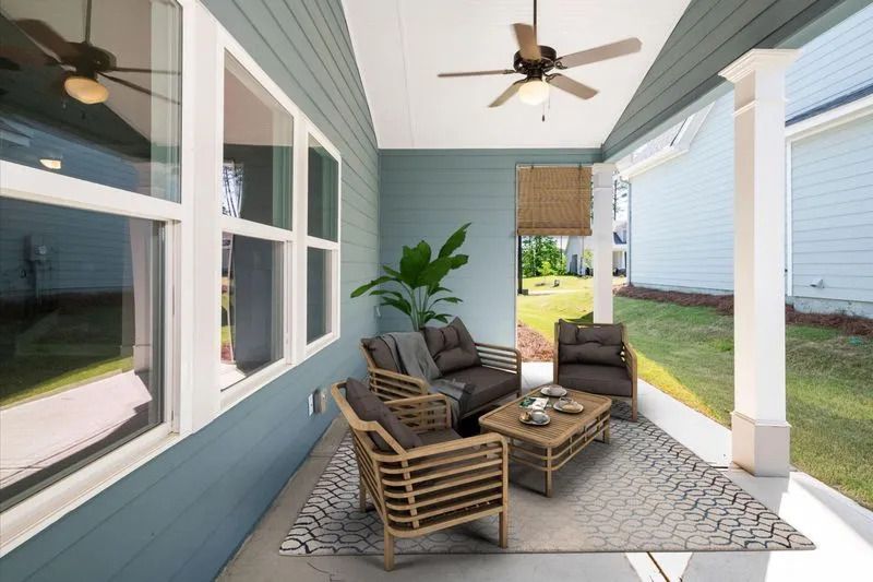 a back patio with furniture and a ceiling fan