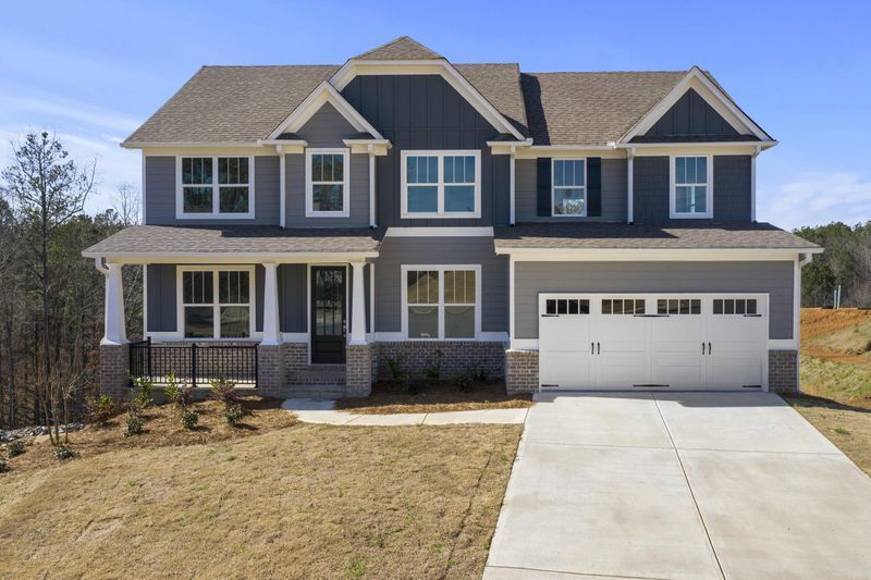 a large house with many windows and a blue and grey exterior