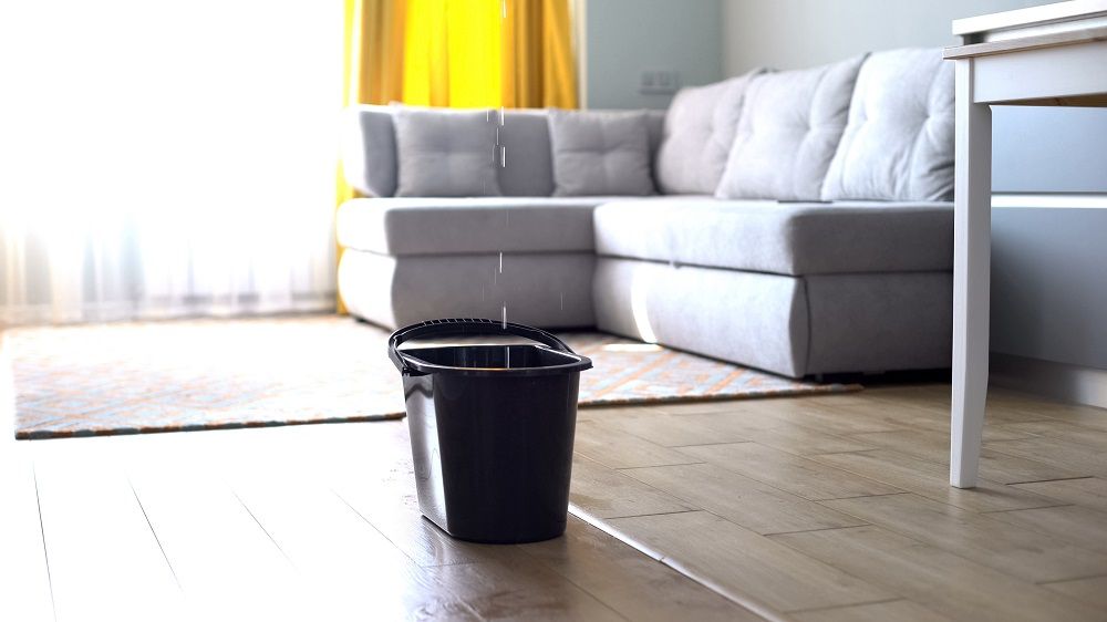 Bucket catching water from leak