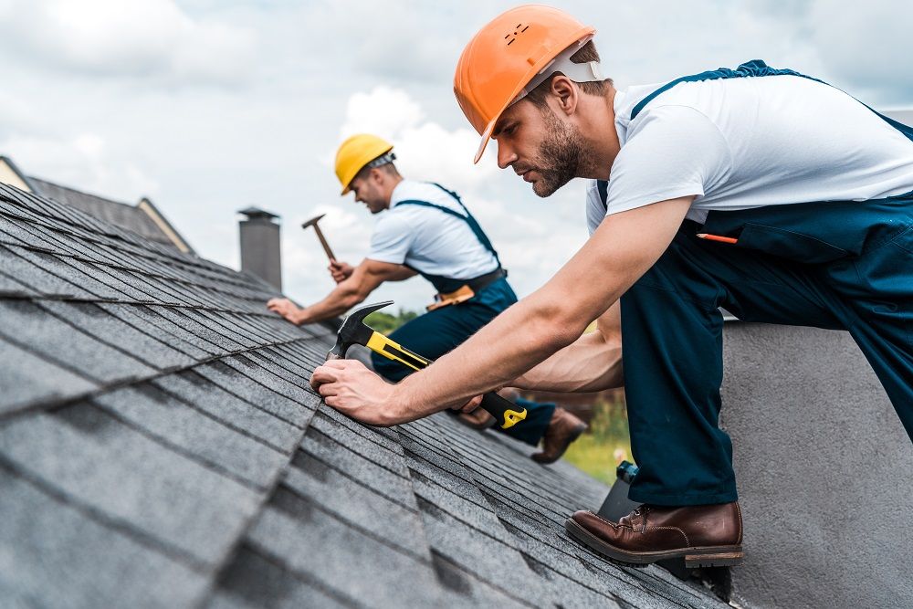 Roofers repairing roof