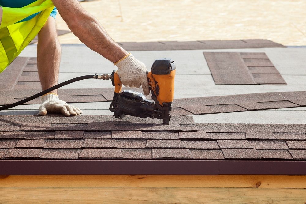 Installing Asphalt Shingles on Roof with Nail Gun