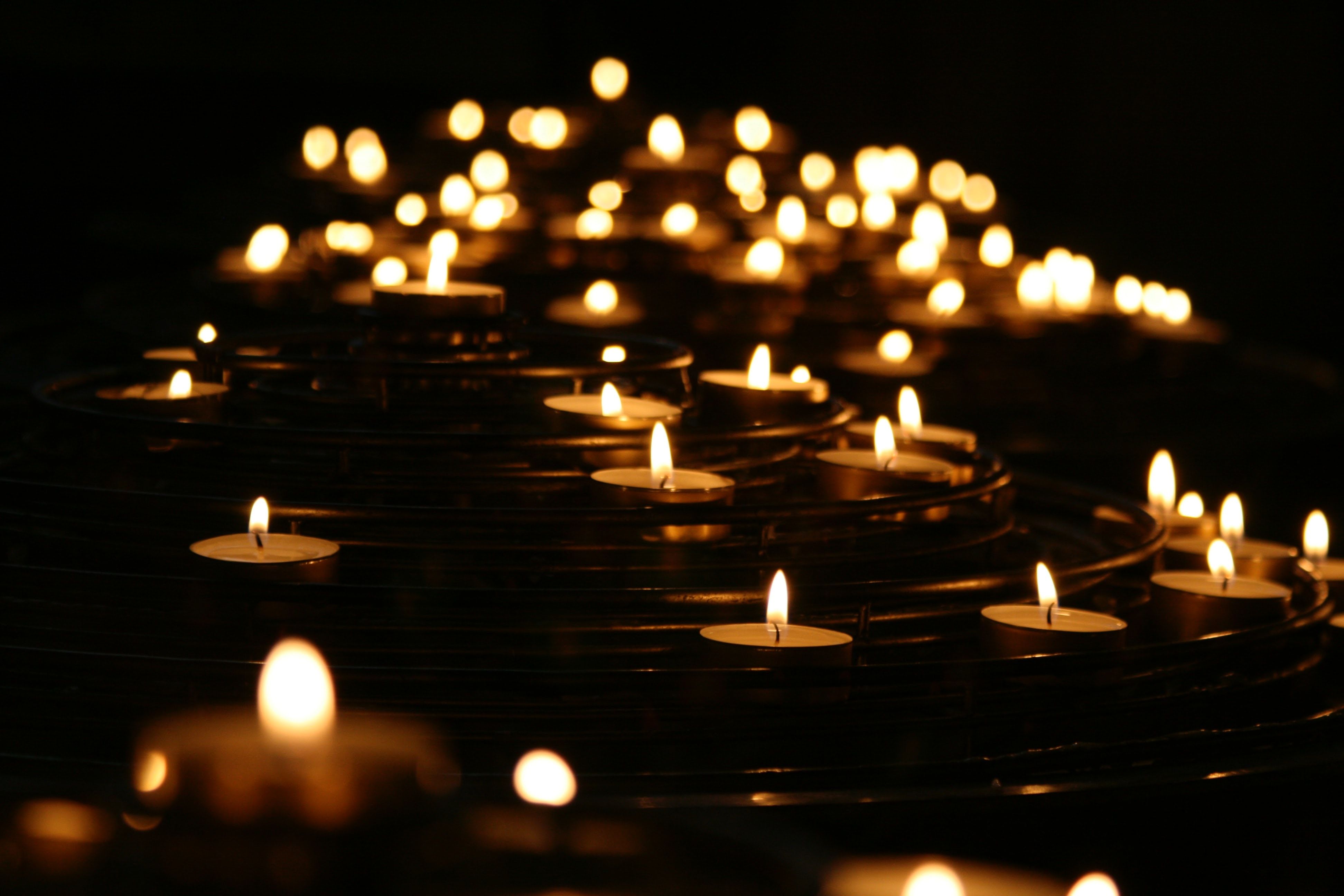 candles floating on water, grief