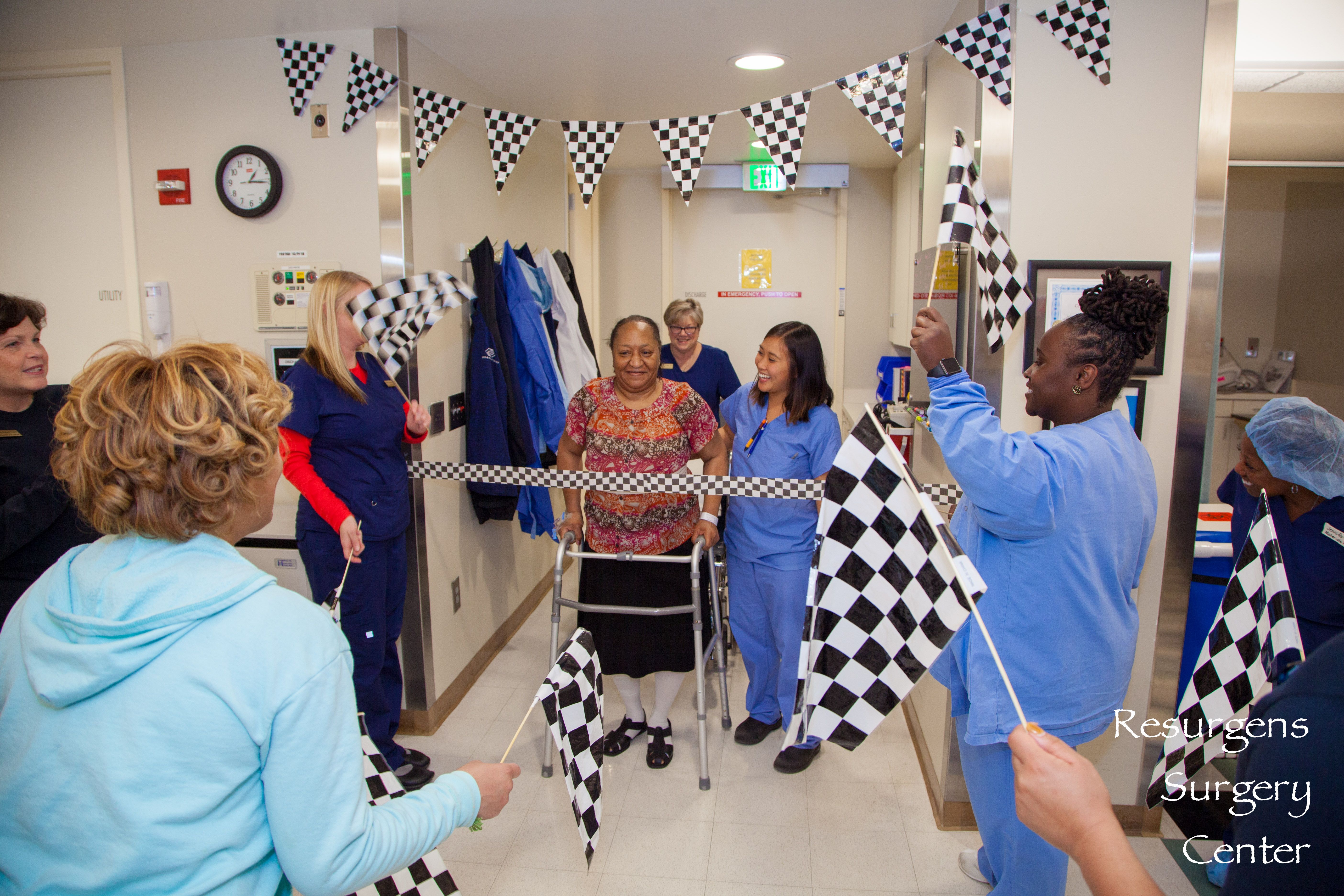 woman with walker crossing finish line