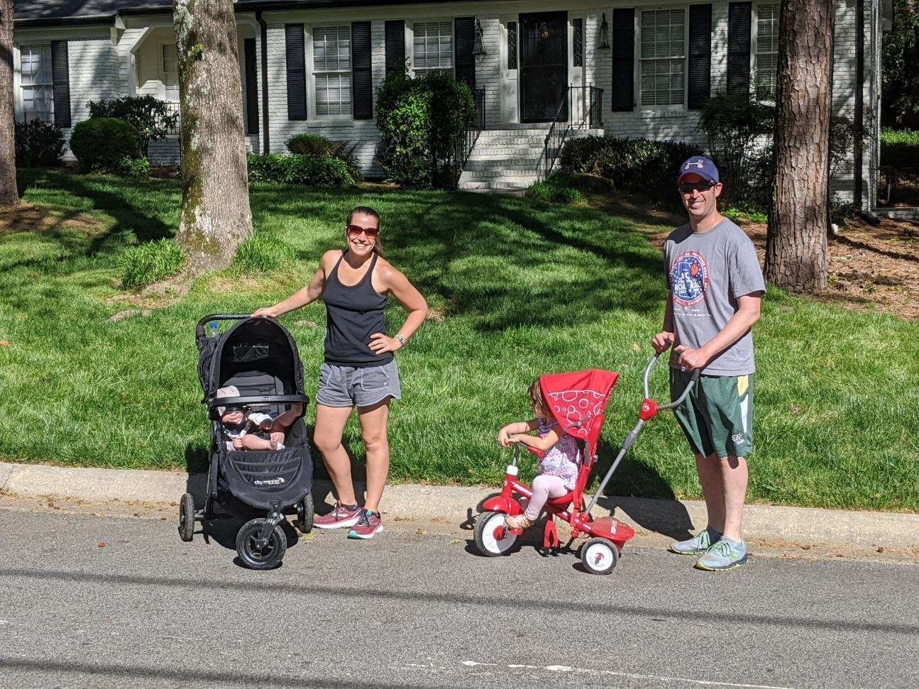 Dr. Levine poses with his wife and children on a sunny street.