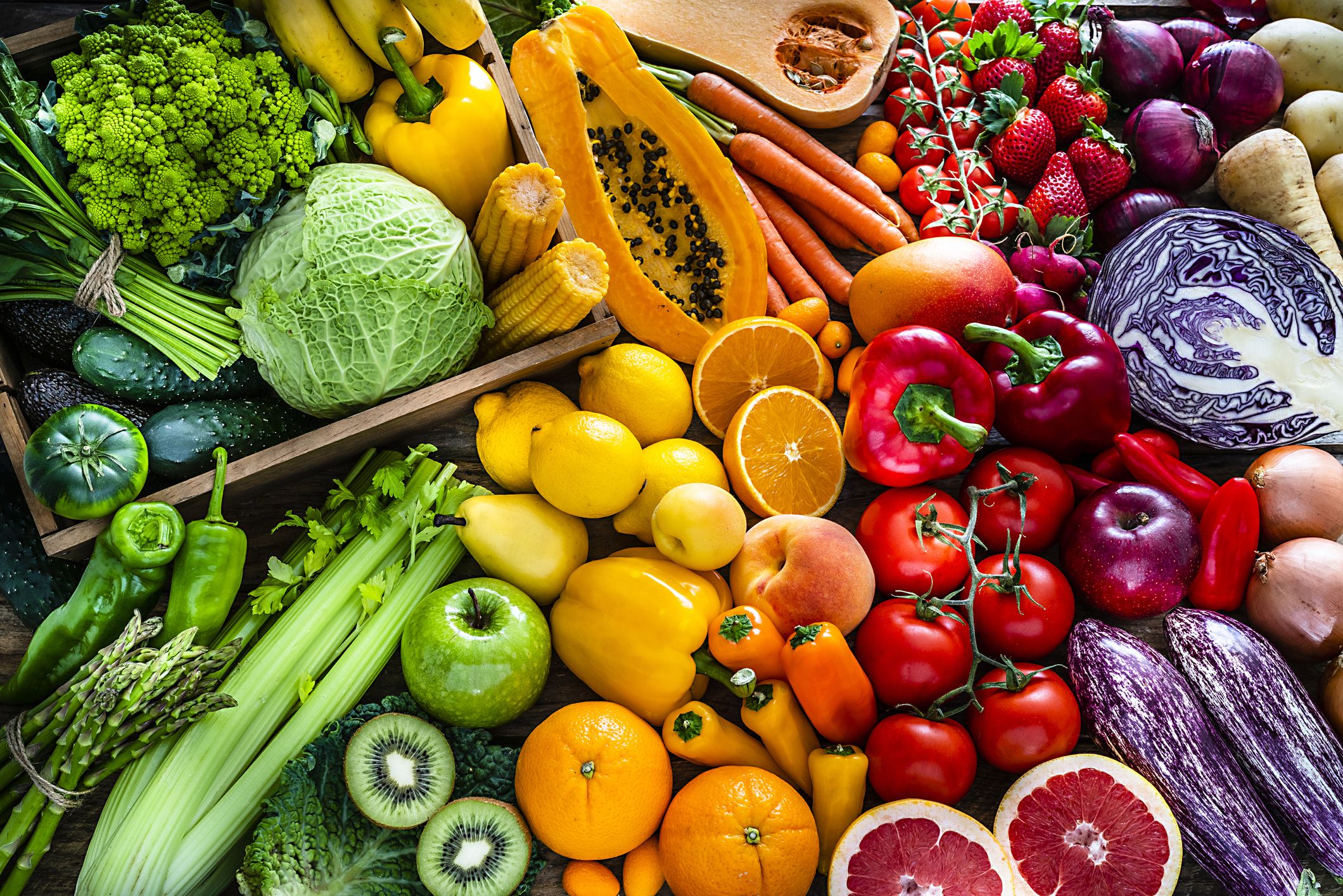 A large spread of fruits and vegetables in crates.