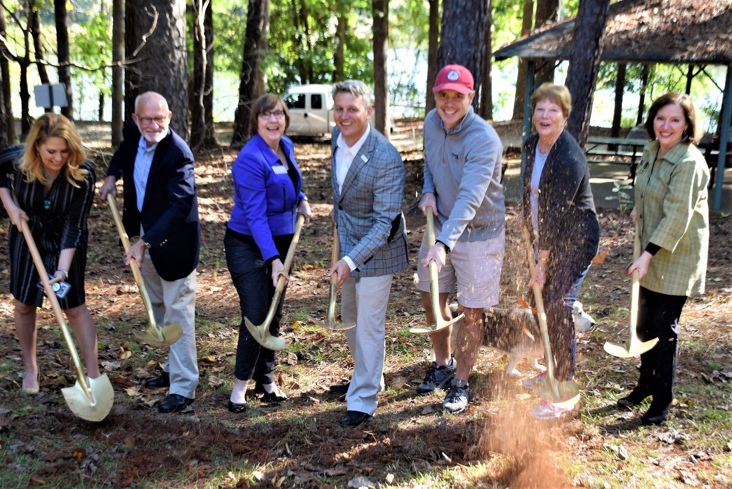A group of Resurgens employees break ground on a new accessible playground.