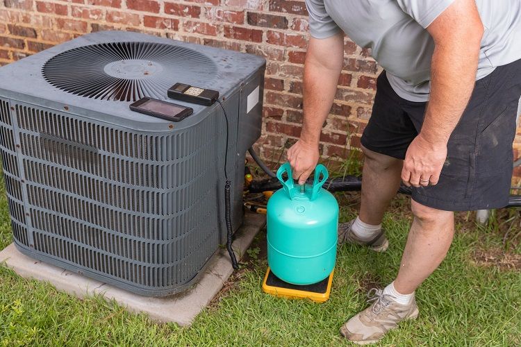 Technician adding refrigerant in Atlanta