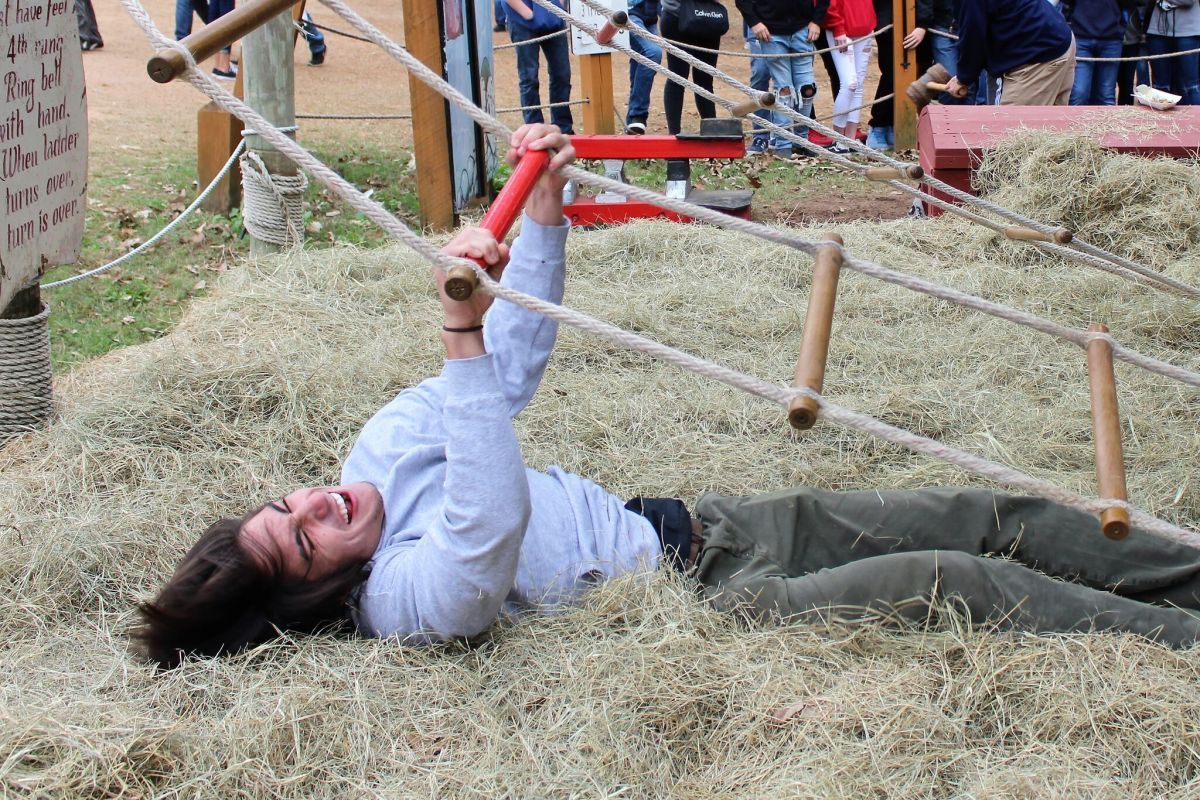 JACOB'S LADDER. Trying his best to make it to the top, senior Kellen Hogan hits the hay again. Ren Fest provides elephant rides, swings, games, and amazing food. (2nd place Feature, Banks Jackson, Willis HS)