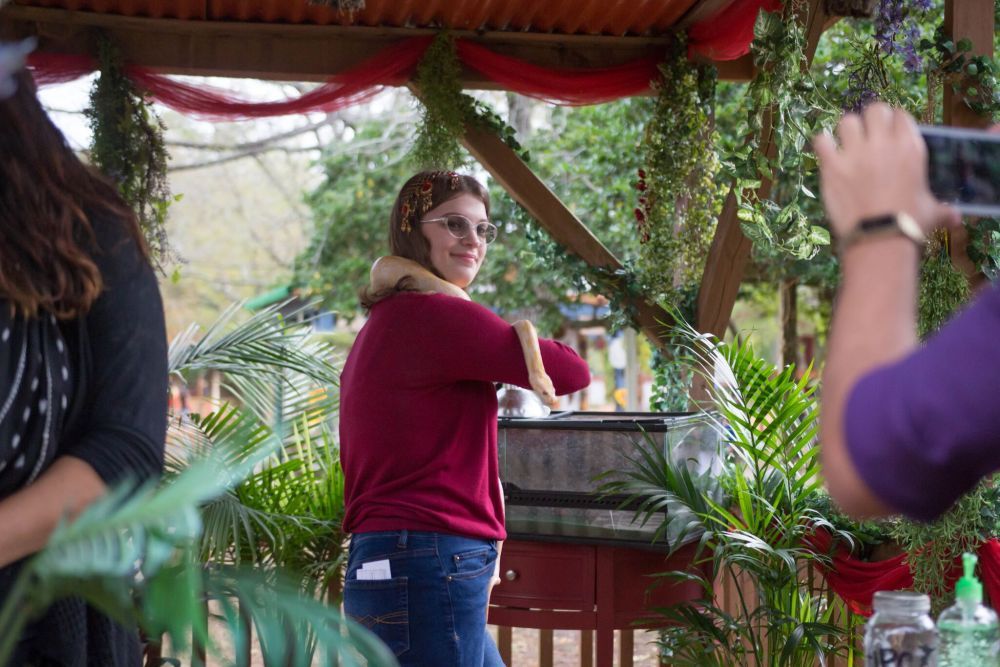 Student poses towards the camera while holding an albino snake during the Texas Renaissance Festival school days. (3rd place, news photo, Ana Hernandez, Navasota HS)