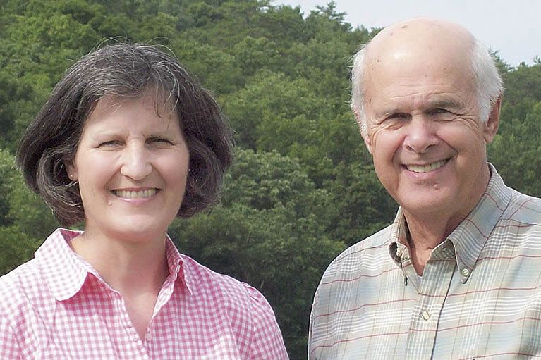 Berry alumni couple in front of trees