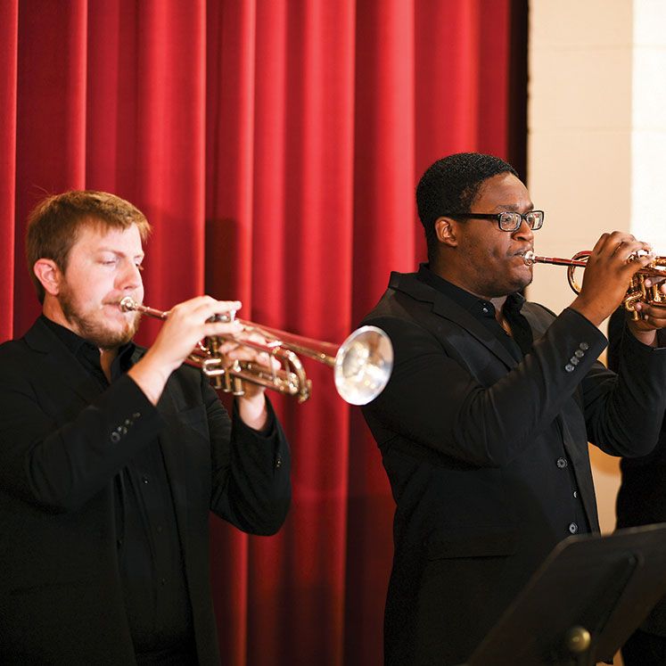 Leif Atchley and Jermaine White play trumpet at a concert