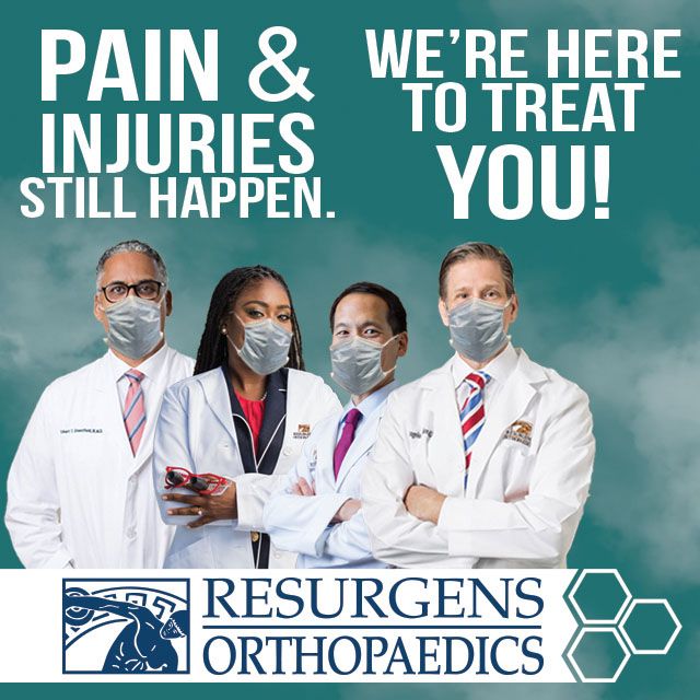 A group of doctors stand below the words &quot;Pain & Injuries Still Happen. We're Here To Help You!&quot;