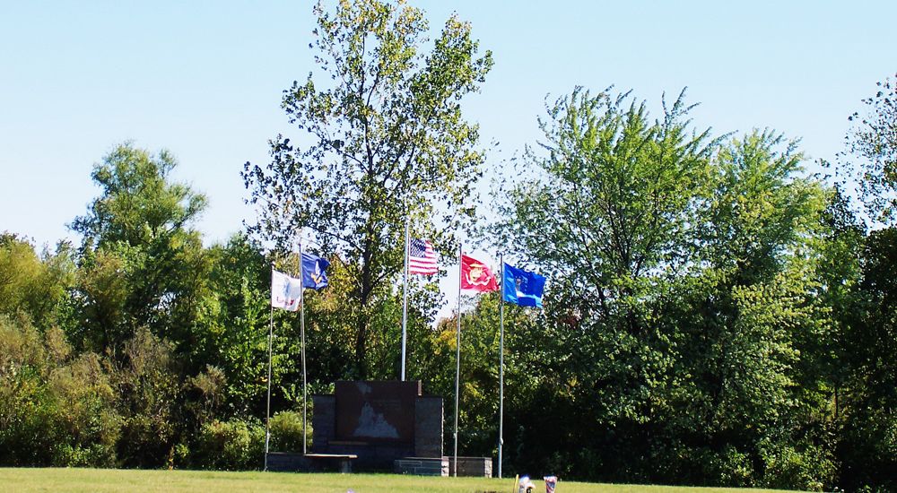 a group of flags on poles
