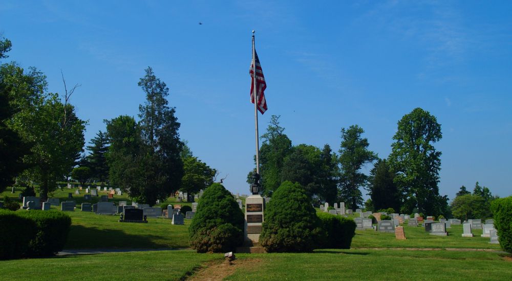 a flagpole in a cemetery
