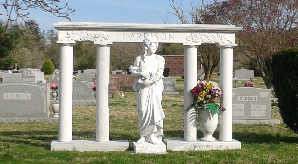 a statue of a person in a cemetery
