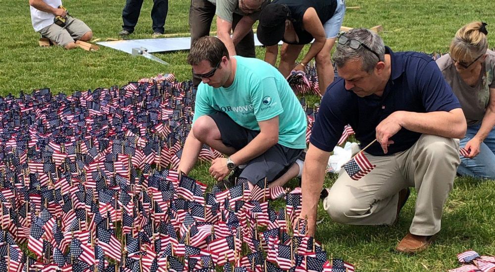 People placing flags at the Delaware Valley Vietnam Veterans Flag Placing event 