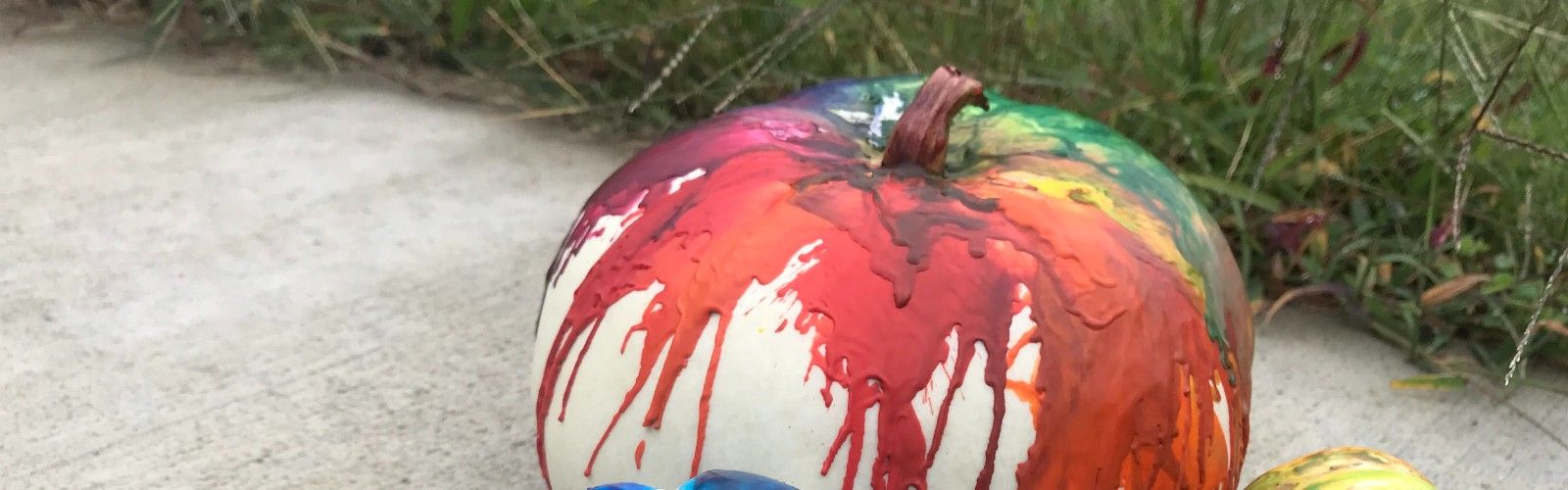 white pumpkins covered with melted crayon wax