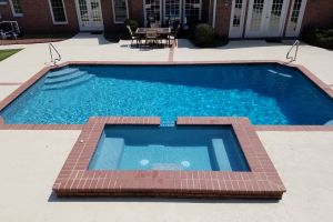 Traditional Gunite, plaster pool with spillover spa.