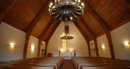 a large church with a chandelier and pews