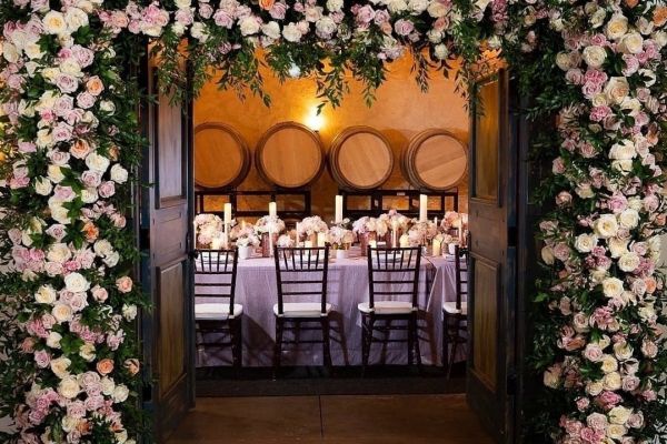 a dining room with a large arch with flowers on it