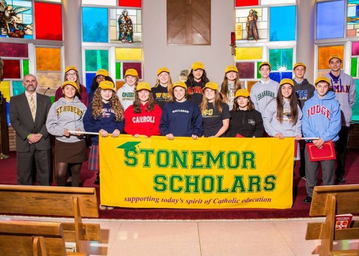2rd Annual StoneMor Scholars Award recipients holding a StoneMor Scholars banner