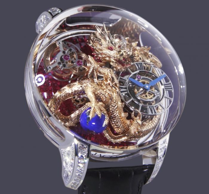 a silver watch with a blue and red design